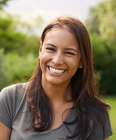 Woman showing off her smile after seeing her BlueCross BlueShield endodontist in Worcester